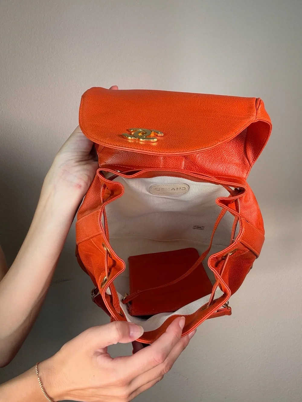 CHANEL Orange Caviar Leather Backpack with CC Trim and Gold Hardware